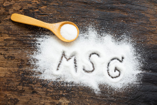 Monosodium glutamate, MSG on wooden spoon. Copy space., a flavor enhancer in many asian food