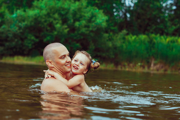 Dad and child bathe in the river