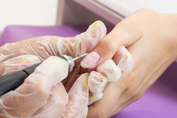 grinding and processing of the nail plate. manicure master makes hardware manicure to the client. nail polishing before applying gel polish. shellac