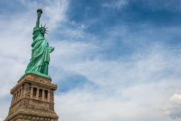 Statue of Liberty on Liberty Island closeup with blue sky in New York City Manhattan - Image