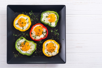 Yellow , red and green pepper with fried eggs