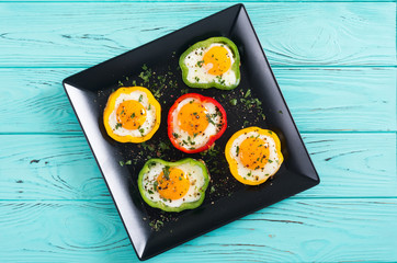 Yellow , red and green pepper with fried eggs