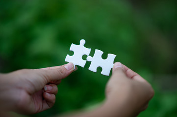 Hands and puzzles, important pieces of teamwork Teamwork concept