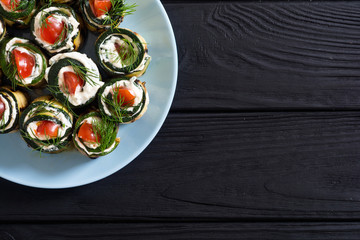 Zucchini rolls with cream cheese , tomatoes and dill