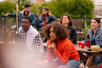 Young hockey fans watching attentively match broadcast