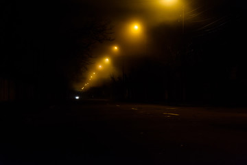 Old street at night illuminated by the lanterns