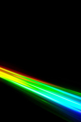 Beams of light refracting and creating a rainbow spectrum of colours against a black background