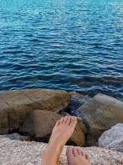 Relaxing by the Rocky Seashore with Bare Feet