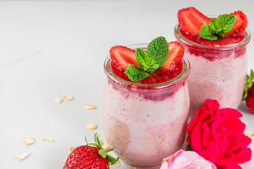 healthy diet breakfast dessert. strawberry overnight oats with fresh berries and mint with rose flowers