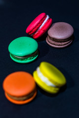 Close-up shot of colored macaroons in different position