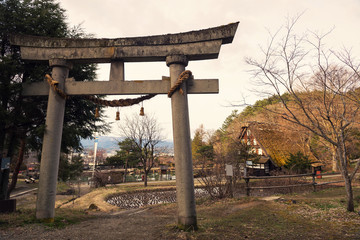 Fototapeta na wymiar Torii gate and old house, Hida no Sato
