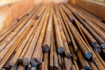 Close up selected focus view stack of straight old rusty high yield stress deformed reinforcement...