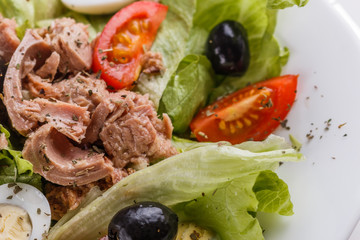 Fresh salad with iceberg lettuce,tomatoes,eggs,canned tuna and olives