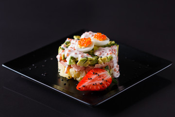 Round salad made of red fish potato and avocado