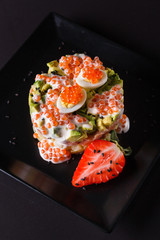 Round salad made of red fish potato and avocado