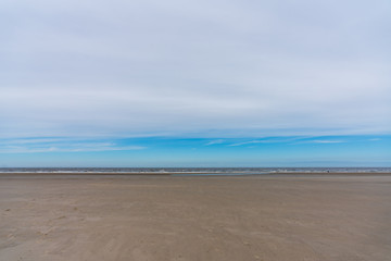 Meer und Sandstrand bei bedeckten Himmel
