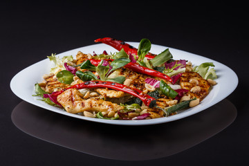 Mexican salad with hot pepper chiken fillet lettuce on plate