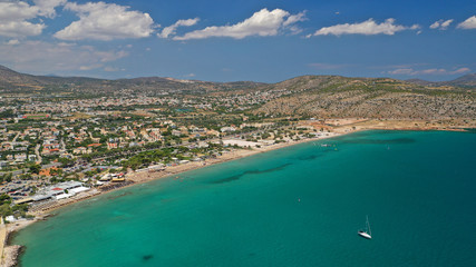 Aerial drone photo of famous seaside village of Varkiza with deep turquoise sandy beaches and clear...
