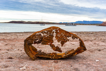 eroded, destroyed  barrel washed on shore