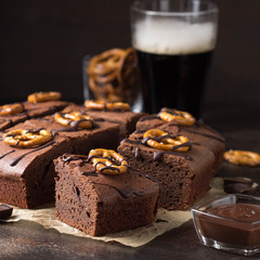 Chocolate brownie on dark beer with salted pretzels and chocolate. Delicious brutal dessert for men, sweet food