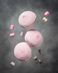 Soaring pink zephyr and marshmallow, levitation food, sweet dessert, flying candy
