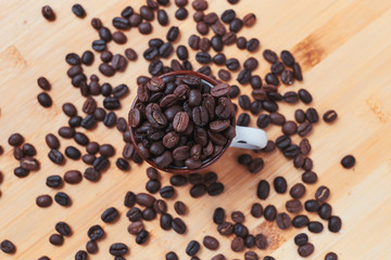 The dark roasted coffee bean in cup