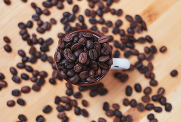 The dark roasted coffee bean in cup