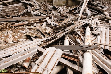 Dilapidated building with reinforced concrete columns and broken slate.