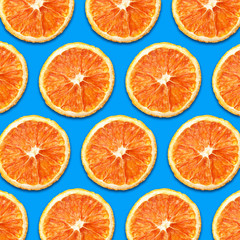 Dry orange slices isolated on blue in design pattern background.