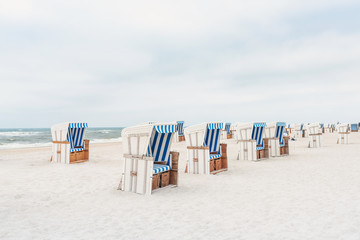 Beach - chairs on the island Sylt. Germany.  Summer cloudy weather.