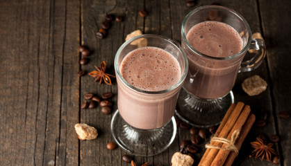 Chocolate, coffee, milk, banana shake on wooden background. Smoothie with cookies. Milkshake. Protein diet. Healthy food concept.