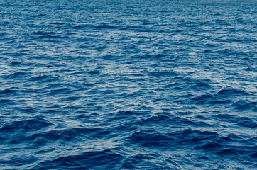 Waves on the surface of the blue sea, background texture
