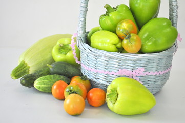 Vegetables in a basket, zucchini, peppers, cucumbers and tomatoes