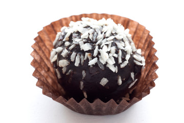 Chocolate cake sprinkled with coconut isolated on white background