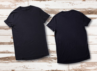 Mockup of blank black tshirt front and rear on white wooden background. Shirt design for man. Flat...