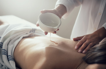 Woman relaxing with a massage in a spa center