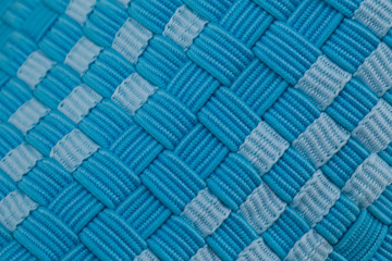 Fragment of a blue fabric sneaker. The texture of the material of sports shoes