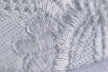 Fragment of white embroidered sneaker fabric. The texture of the material of sports shoes
