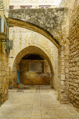 Fototapeta premium Alley with historic tablet, in the old city of Acre