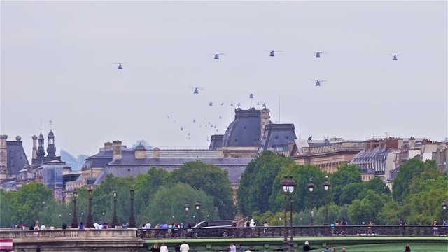 Paris, France - July 14 2019: Bastille Day Aircrafts Parade. Helicopter Squadrons are flying over the seine river.