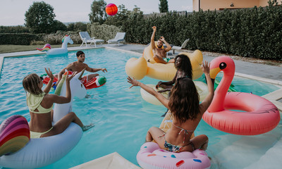 group of friends having fun in the swimming pool