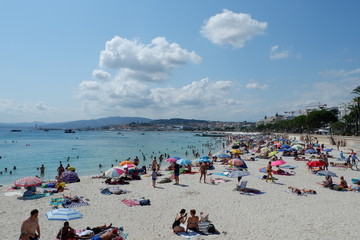 beach with umbrellas and chaise lounges