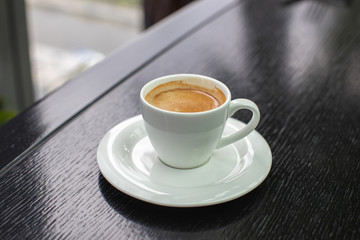 white Cup of cappuccino coffee with foam on the table in a cafe or restaurant