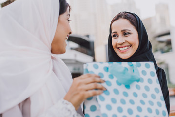 Two arabian girls spending time togehter outdoor making activities