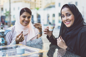 Two arabian girls spending time togehter outdoor making activities