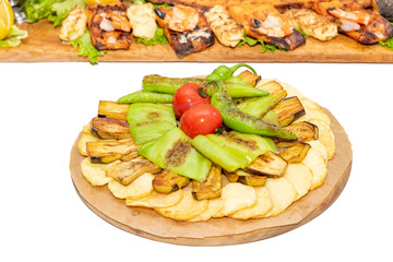 Grilled vegetables on cutting board isolated on white background