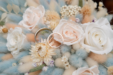 Bouquet with beautiful roses and wedding rings