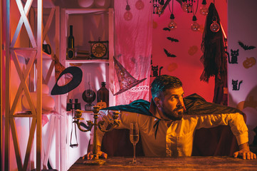 Halloween party. Holiday concept. Preparing for Halloween. Man drinking alcoholic drink on the...