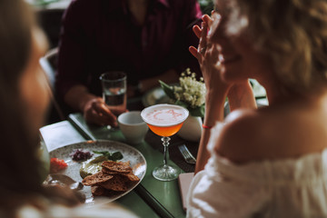 Friends chatting and enjoying drinks in cafe