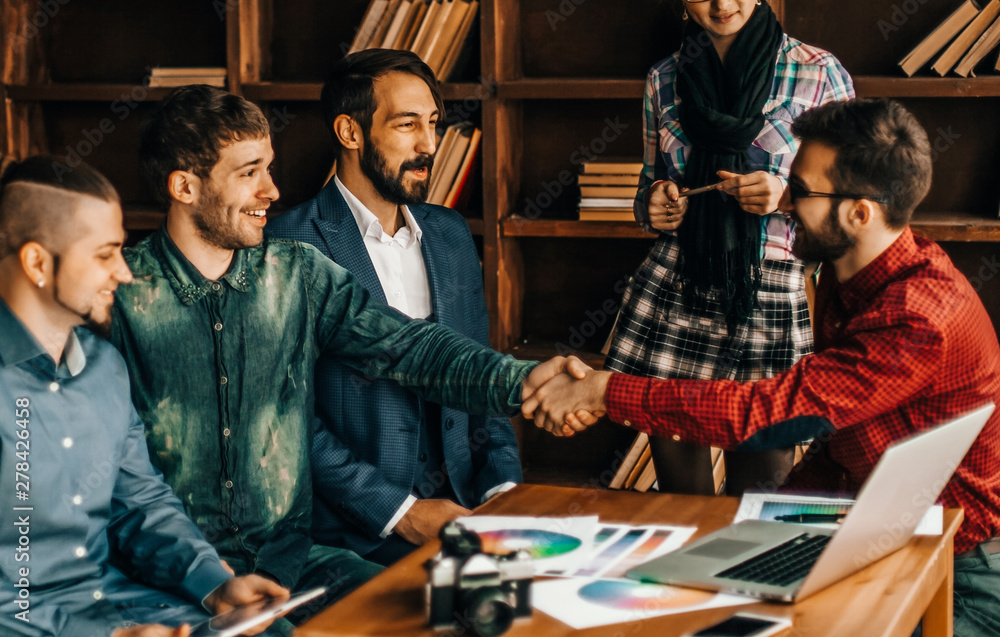 Wall mural advertising Manager with a handshake greets the customer